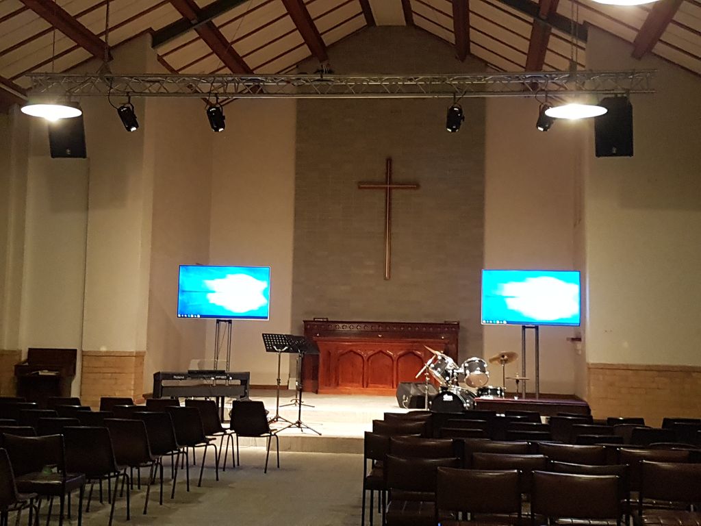 Twin large-format displays installed either side of a church chancel